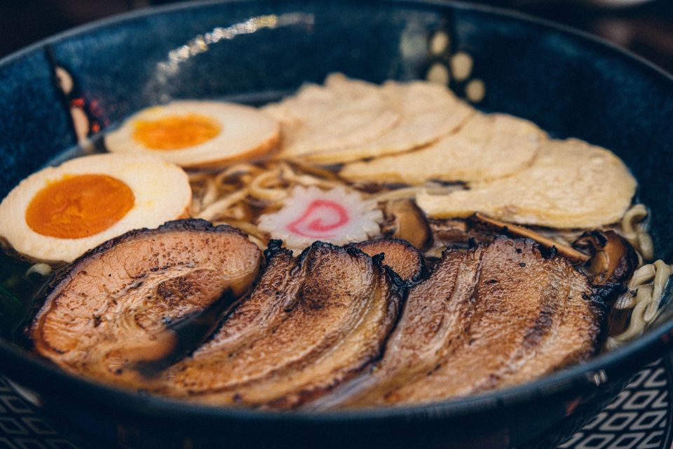 A dish of ramen with meat and a boiled egg on top